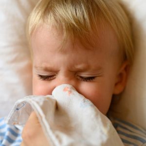 The Little Boy Blows His Nose In His Handkerchief Runny Nose In A Child The Concept Of Colds Allergy T20 Ywj7we.jpg